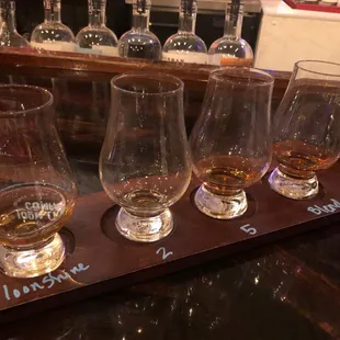 a row of glasses on a bar