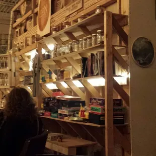 Wall of flavor jars, games, and merchandise.