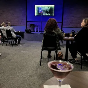 people sitting in chairs and watching tv