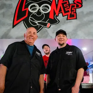 two men standing in front of a bar