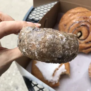 a hand holding a doughnut