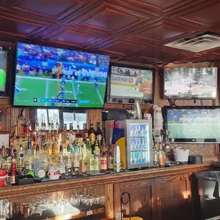 a bar with multiple televisions