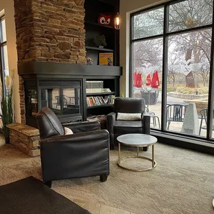 a coffeehouse with a fireplace and chairs