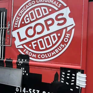 a red food truck with a logo on it