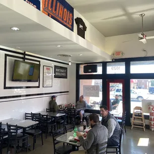 people sitting at tables in a restaurant