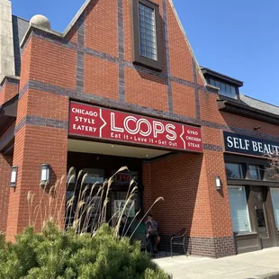 the front of a brick building with a sign that says,