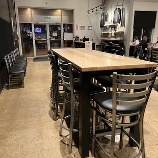 a bar with stools and tables