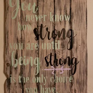 a wooden sign with words on it