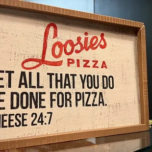 a sign that says let all that you do be done for pizza cheese 24 7 7