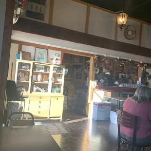 a woman sitting at a table in a restaurant