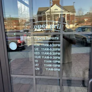 Front door  with operating hours...