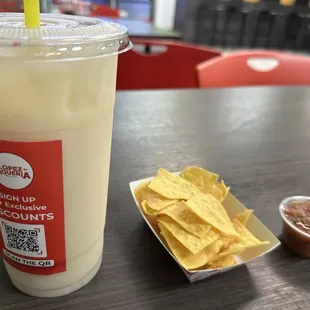 Horchata drink and complimentary tortilla chips and salsa.