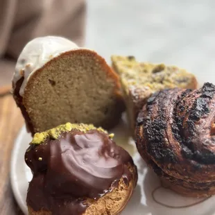 counter clock wise: Chocolate pistachio cream puff, poppy seed &amp; chocolate babka, pistachio lemon tart, &amp; olive oil earl grey cake