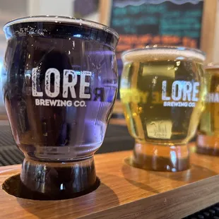 a row of beer glasses on a bar