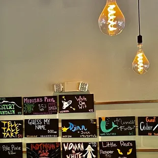 a wall of beer signs and a lightbulb