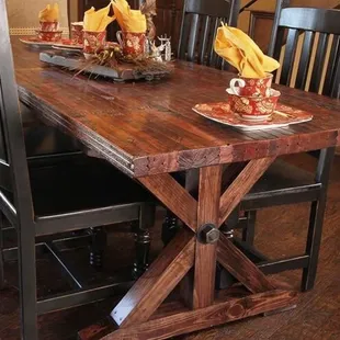 Farmhouse style dining table made from vintage reclaimed railroad car flooring.