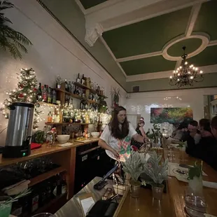 a woman behind the bar at a restaurant