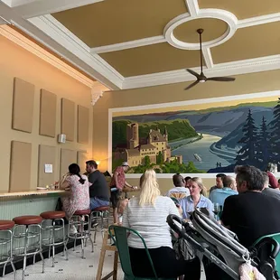 people sitting at tables in a restaurant
