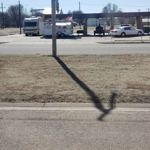 the shadow of a street sign
