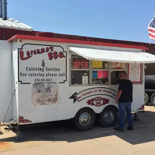 a man standing in front of a food truck