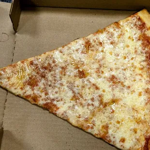 a slice of cheese pizza in a box