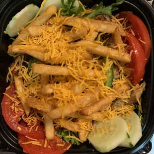 Grilled chicken salad with french fries.