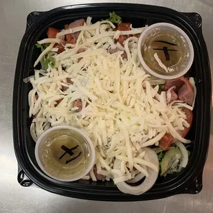 Tossed salad with pizza cheese.