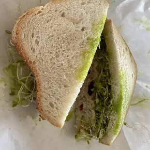 Sliced sourdough, garlic spread, lettuce, sprouts, chicken salad