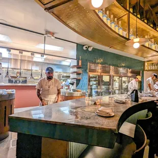 a man standing at a counter in a restaurant