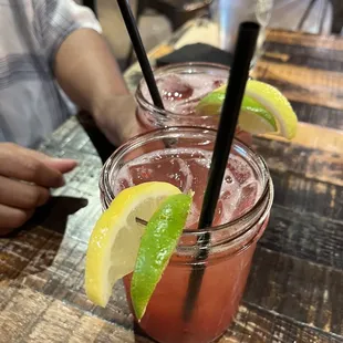 two glasses of drink with lemon wedges