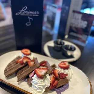 Ube waffles with ube icing, strawberries and chai maple syrup