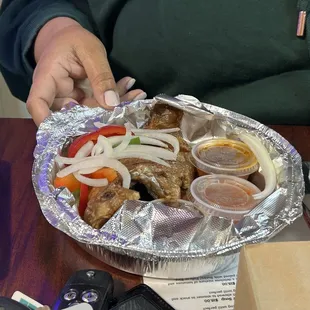 Fried fish, vegetables and sauces including Shito or shitor din a hot black pepper sauce.