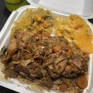 Brown stew chicken, rice and peas, cabbage, and Mac n cheese