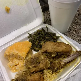 Deliciousness in a to go container!  (curry chicken, rice, Mac n cheese, collards). Pretty sure this was sent from heaven!