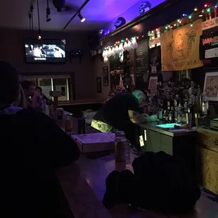 people sitting at a bar watching tv