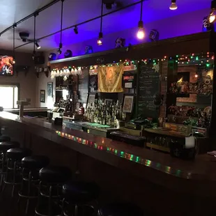 a dimly lit bar with stools