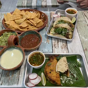 Quesa-birria taco, (half-eaten) chorizo taco, asada tacos and the Trio Dip.