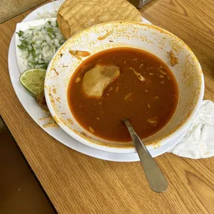 Pozole with tostadas served with a side of onion and cilantro and cabbage. Unusual but ok.