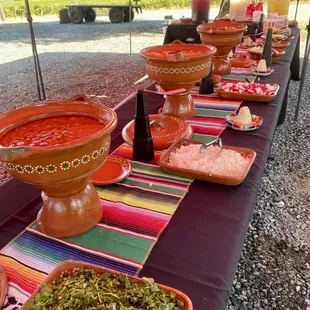 a long table with bowls of food