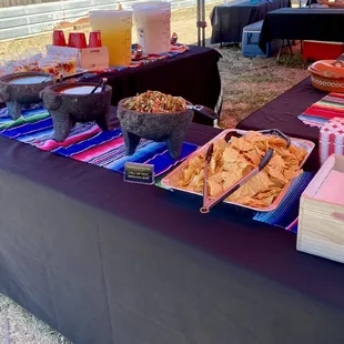 a table of snacks and drinks