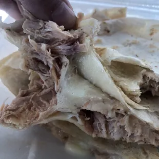 a person picking up a piece of food
