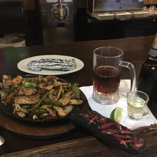 a plate of food and a glass of beer