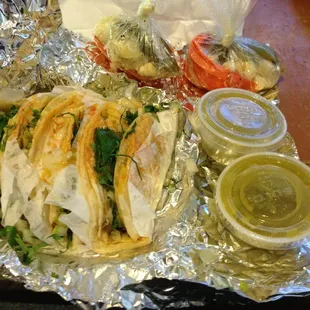 Steak and chorizo (Mexican sausage) tacos. Green salsa, and spicy vegetables.