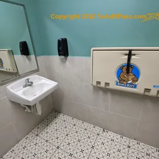 a bathroom with a sink and mirror