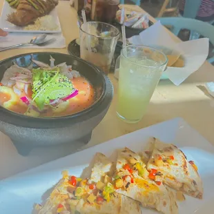 a plate of quesadillas and a bowl of soup