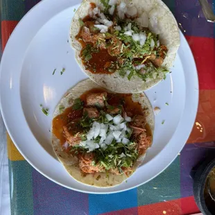 Spicy pork and Morita seasoned pork flour tacos with cilantro and onion