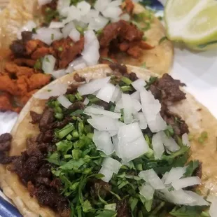 1 asada and 1 al pastor taco