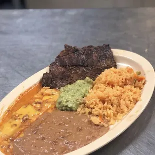 Delicious tampiqueña steak with one cheese enchilada served with rice, beans and guacamole.