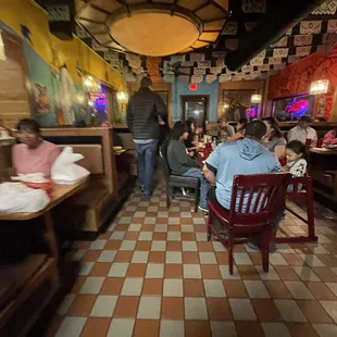 people sitting at tables in a restaurant
