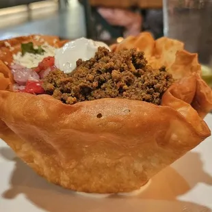 TACO SALAD King-sized tortilla bowl, crisp lettuce, Mexican rice, queso fresco, pico de gallo, cilantro, sour cream, tequila lime dressing